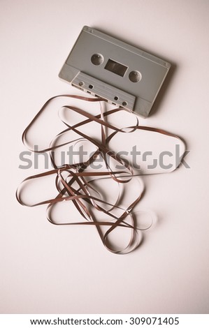 Cassette with mess of tape , retro image processed
