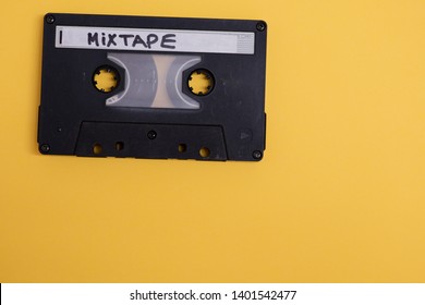 Cassette with mixtape written isolated against yellow background