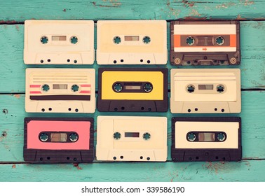 Cassette tapes over blue textured wooden table . top view. retro filter