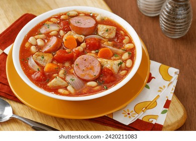 Cassoulet is a hearty French dish originating from the south. It's a slow-cooked casserole of white beans, sausage, duck or pork, and often confit, simmered in a rich broth.