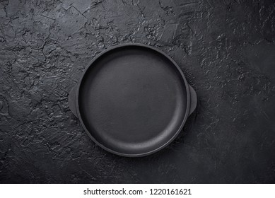 Cast Iron Frying Pan On Black Slate Backgound