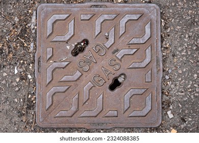 Cast Iron Gas Cover to Gas Utility Pipe in Pavement UK - Shutterstock ID 2324088385