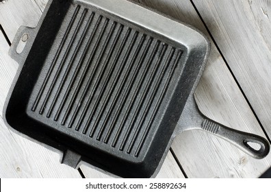 Cast Iron Griddle Pan On Wooden Background