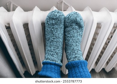 cast iron heating radiators, knitted socks with radiators, women's feet - Powered by Shutterstock