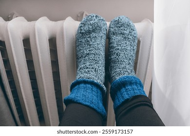 cast iron heating radiators, knitted socks with radiators, women's feet - Powered by Shutterstock