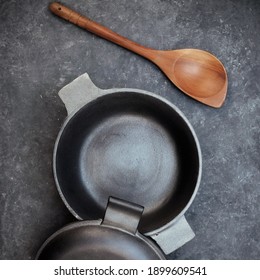 Cast Iron Pot With Lid On Black Isolated Background Top View. Empty Cast Iron Pot On Grunge Black Table, Overhead View.