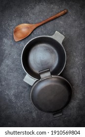 Cast Iron Pot With Lid On Black Isolated Background Top View. Empty Cast Iron Pot On Grunge Black Table, Overhead View.