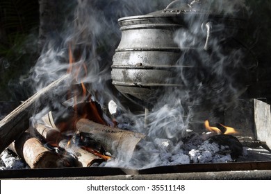 A cast iron pot is used for traditional cooking on an open fire in South Africa.