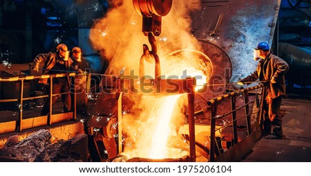 Cast iron process, liquid molten metal pouring in ladle, industrial metallurgical foundry factory, heavy industry