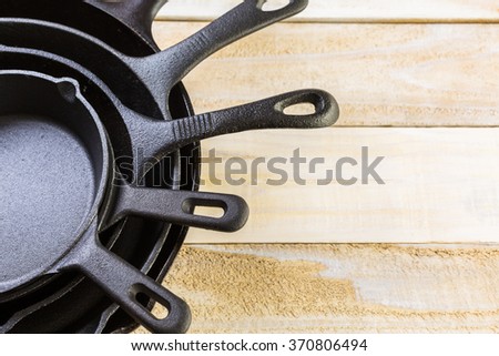 Cast iron skillet on rustic wood table.