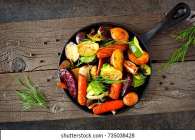 Cast Iron Skillet Of Roasted Autumn Vegetables Against A Rustic Dark Background