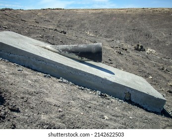 Cast Iron Wastewater Outlet Pipe Daylighting From The Treatment Lagoon Earthen Berm