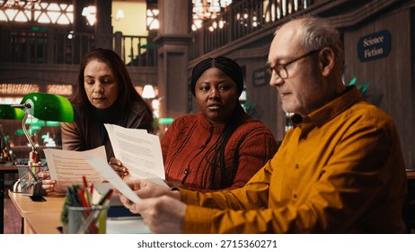 Cast members practicing script reading for a classic drama play in a library, showing dedication to acting and passion for character development. Theatrical arts role play.