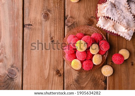 Castagnole on wooden background. Traditional sweet pastries during the carnival period in italy. Street food, round biscuits with sugar for the carnival of Venice. Copy space. 