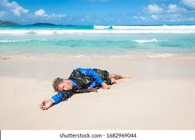 Castaway survivor businessman washed up on a tropical beach in a ragged torn suit - Shutterstock ID 1682969044