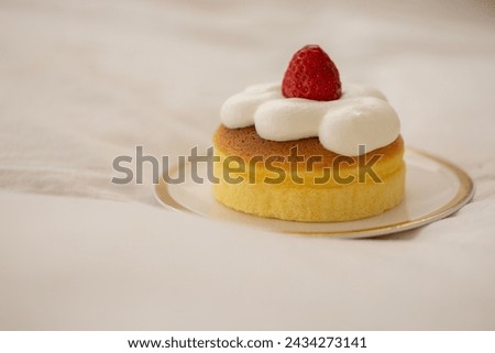 Castera with strawberries and whipped cream on top