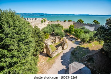 Castiglione del Lago fortress fort wall wide high angle view in Umbria, Italy Rocca Medievale del Leone by lake Trasimeno in sunny summer with old ruins
