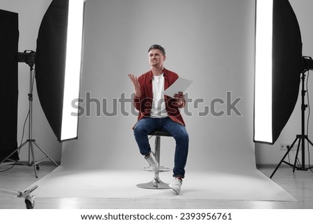 Casting call. Emotional man with script performing in studio