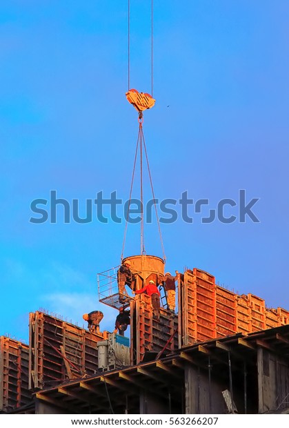 Casting of the concrete work\
in construction. The cables of a construction crane. The vertical\
frame.