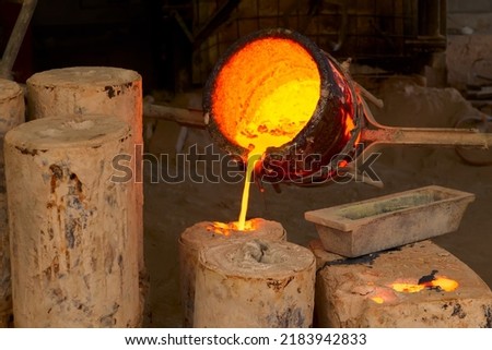 Casting melting hot bronze in pot