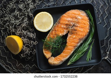 Cast-iron Tray With Grilled Salmon Steak On A Fishing Net, Top View, Horizontal Shot, Selective Focus