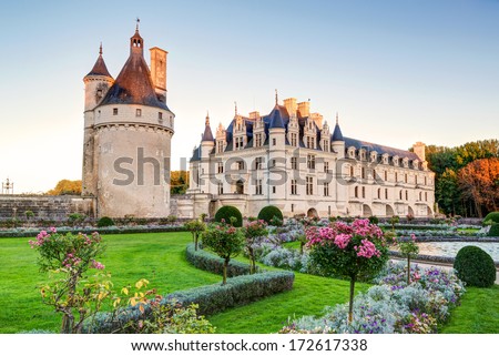 Castle Chenonceau at sunset, Loire Valley, France. This chateau is travel destination in Europe. Nice scenery of old French castle with flower garden. Scenic view of Renaissance palace at Loire.