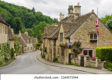 Castle Combe Village In Cotswolds, UK - Small Medieval Houses Aligned Along The Road - Summer Day