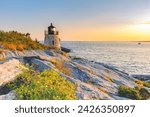 Castle Hill Lighthouse at twilight during the golden hour just before sunset, Newport, Rhode Island, USA. The beautiful granite tower, completed in 1890, is built right into the cliff.