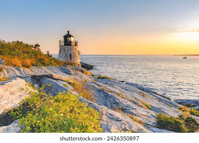 Castle Hill Lighthouse at twilight during the golden hour just before sunset, Newport, Rhode Island, USA. The beautiful granite tower, completed in 1890, is built right into the cliff. - Powered by Shutterstock