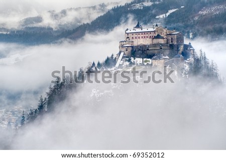Castle Hohenwerfen by Salzburg high over clouds on a misty mountain in the Alps