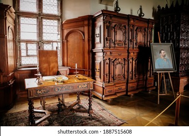 Castle interior. Cabinet with writing desk with a book and candlesticks, room with baroque and renaissance wooden carved furniture, Castle Bouzov, Moravia, Czech Republic, July 05, 2018