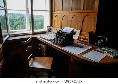 Castle interior, wooden writing desk, table near windows, black vintage antique typewriter, blank sheet of paper inserted, renaissance chateau Nove mesto nad Metuji, Czech Republic, June 12, 2021