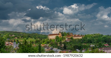 Castle on big hill in Vimperk town in spring sunny and cloudy color day