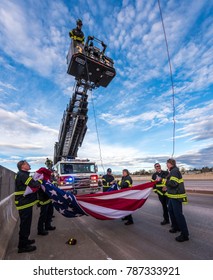 CASTLE ROCK, COLORADO/USA - JANUARY 5, 2018: South Metro Fire And Rescue Hoist A Large American Flag For The Funeral Procession On Interstate-25 For Douglas County Deputy Sheriff Zackari Parrish. 