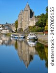 Castle of Rohan reflecting in the water of Oust, part of canal Nantes at Brest, at Josselin, a commune in the Morbihan department in Brittany in north-western France