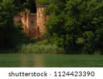 Castle ruins by the lake in green environment. Castle of Klaudyna Potocka in the Wielkopolski National Park, Poznan, Poland.