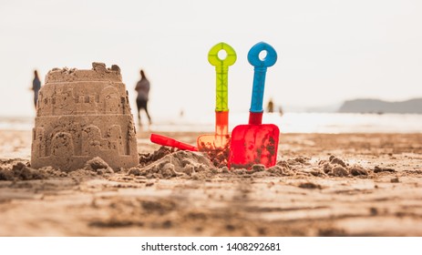 Castle sand and children's toy on the sand beach.Shovel toy for kid play on the sea side. Travel on the beach concept. - Powered by Shutterstock