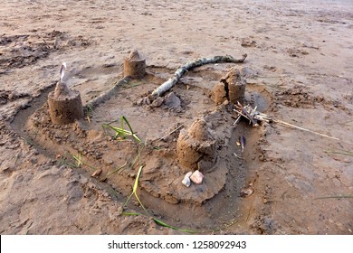 A Castle Of Sand With Towers And Moat.