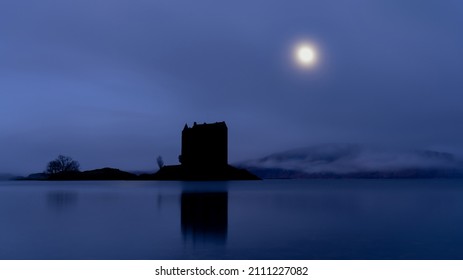 Castle Stalker Silhouette With The Moon At Night. Castle On An Island Near Glencoe And Oban In The Scottish Highlands. 