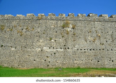 castle wall green grass blue sky
