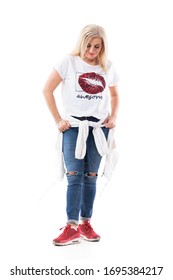 Casual Blonde Middle Aged Woman Getting Dressed Looking Down On Sneakers. Full Body Length Isolated On White Background.