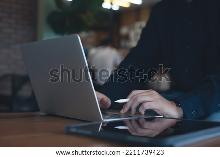 Casual business man using on laptop computer surfing the internet in coffee shop. Man freelancer online working in cafe, freelance lifestyle, telecommuting, telework, remotely work concept