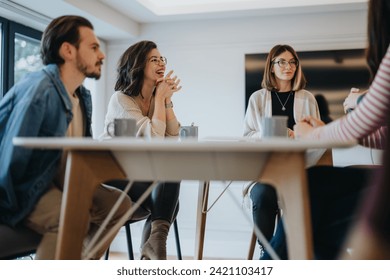 Casual business meeting with creative team discussing ideas in modern office. - Powered by Shutterstock