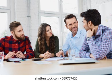 Casual Business Partners Talking During Business Meeting In Office.