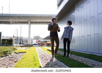 Casual Business People Outside, Man And Woman,  Walking And Talking About Business