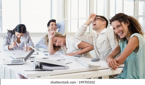 Casual Business Team Laughing During Meeting In The Office
