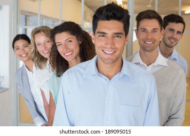 Casual Business Team Smiling At Camera Together In The Office