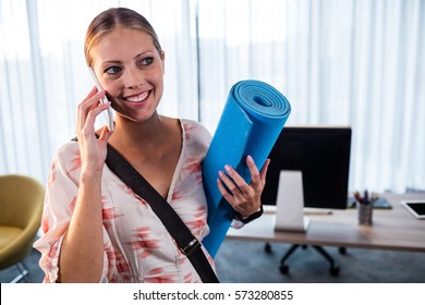 Casual Business Woman Holding Yoga Mat In The Office