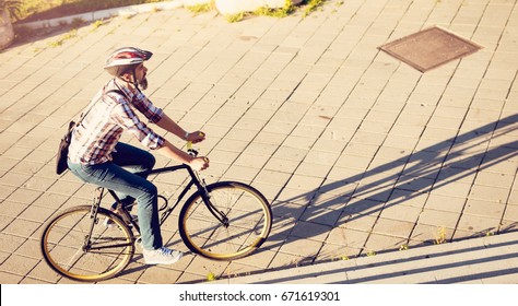 Casual Businessman With A Helmet Going To Work By Bicycle.