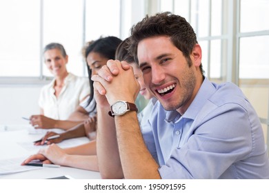 Casual businessman laughing during meeting in the office